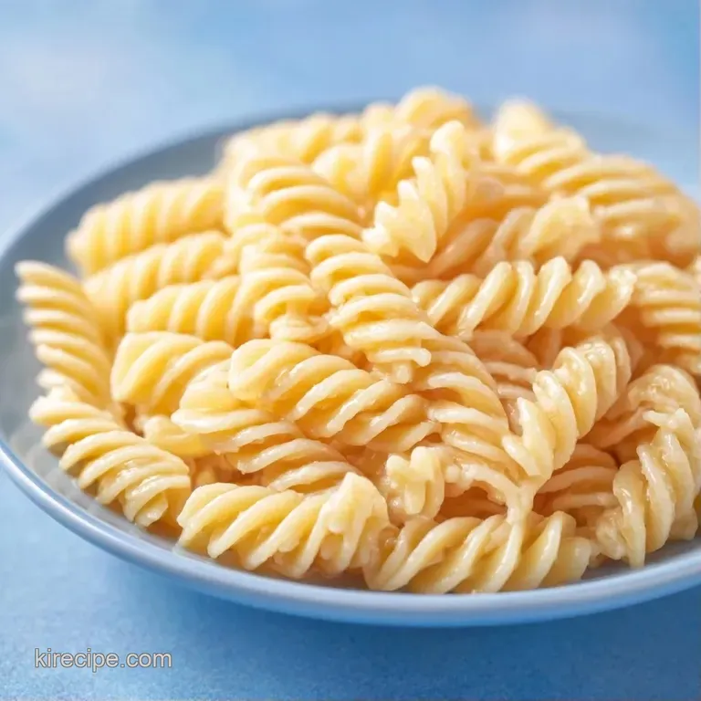 A bright bowl of pasta salad garnished with fresh parsley and paprika, set against a light linen background.