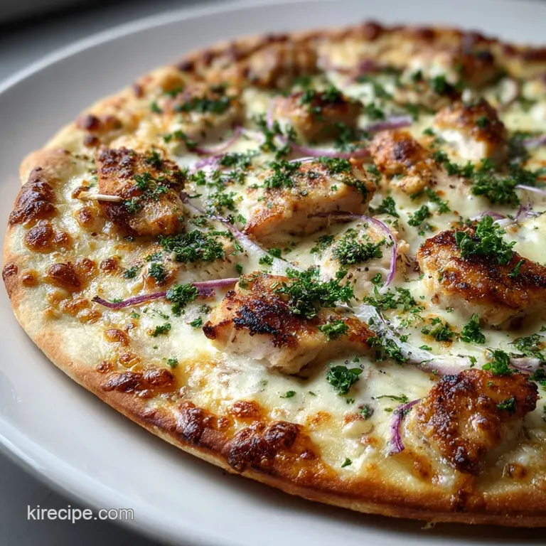 Slice of loaded pizza presented; melted cheese glistening, showcasing the golden crust with visible chicken and garlic.