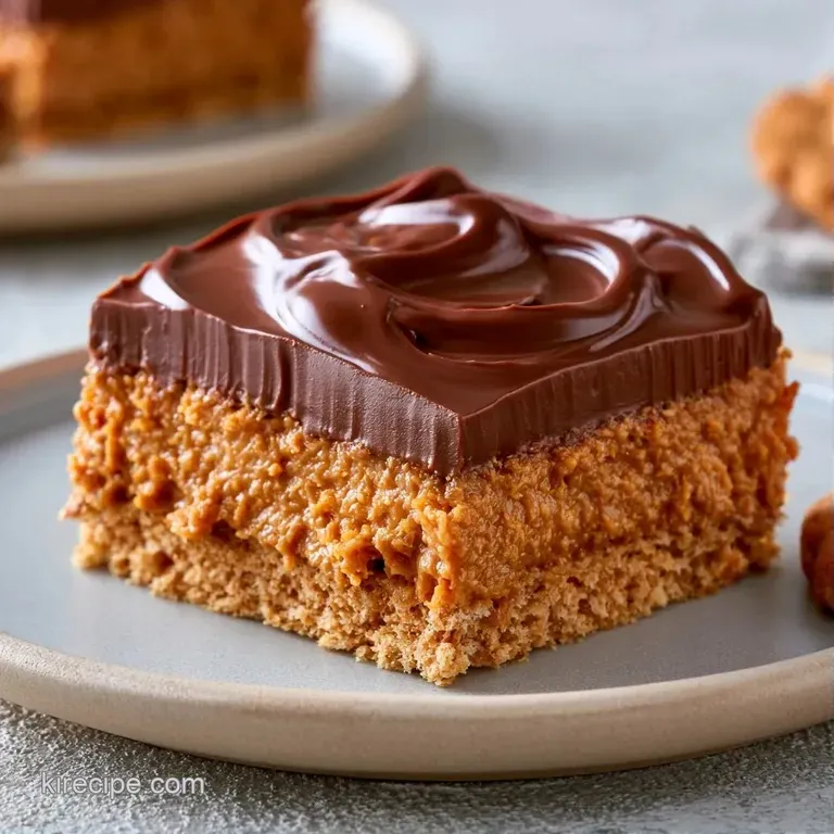 Neatly stacked tan peanut butter squares on a white ceramic plate, finished with a drizzle of dark chocolate.