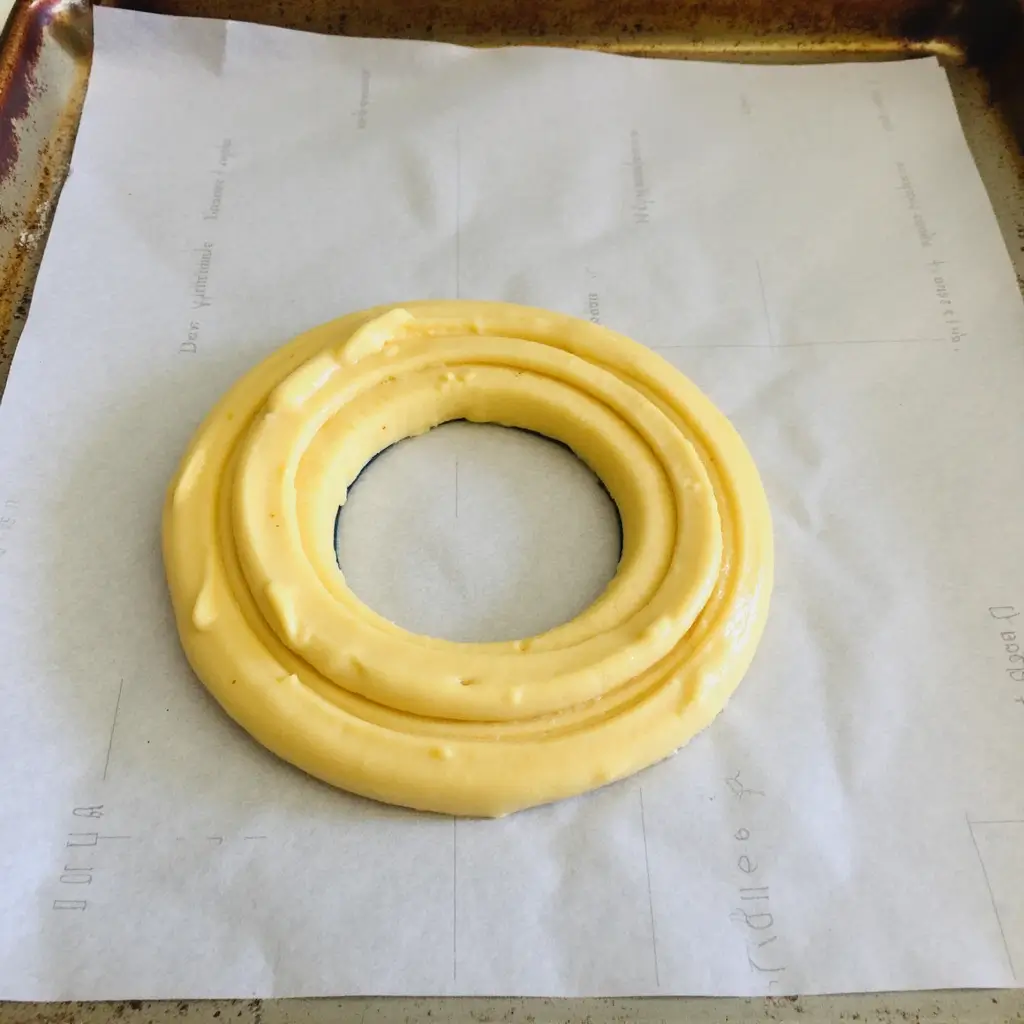 Pastry With Frosting and Jelly Filling in Ring Shape